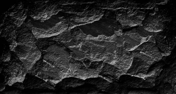 istock Black and white stone grunge background, rough rock wall texture 1180763134