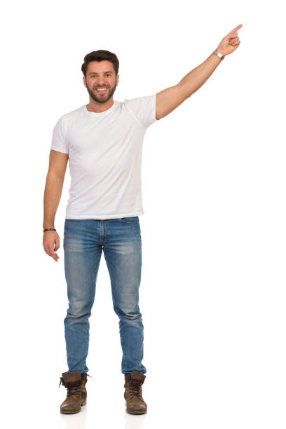 istock Young Man In Jeans And White T-shirt Is Standing And Directing. Front View 1180763476
