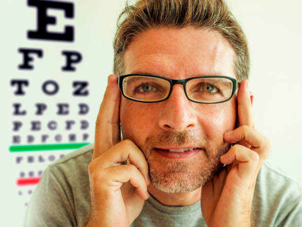 istock Attractive man checking vision trying glasses at optometrist . Cheerful and handsome guy on his 40s during optical examination testing spectacles for correcting myopia in eyes and health care 1180764757