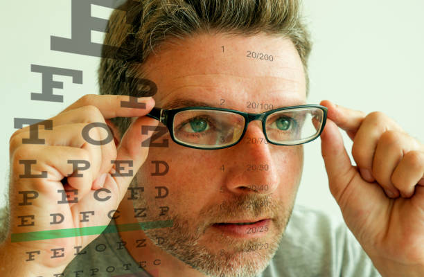 istock Attractive man checking vision trying glasses at optometrist . Cheerful and handsome guy on his 40s during optical examination testing spectacles for correcting myopia in eyes and health care 1180764759
