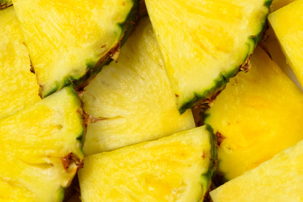 istock Pineapple juicy yellow slices background. Top view. 1180764814