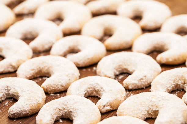 sweet food / bakery for christmas: Many vanilla crescents on wooden board