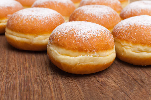 istock Many donuts / doughnuts on wooden board 1180768492