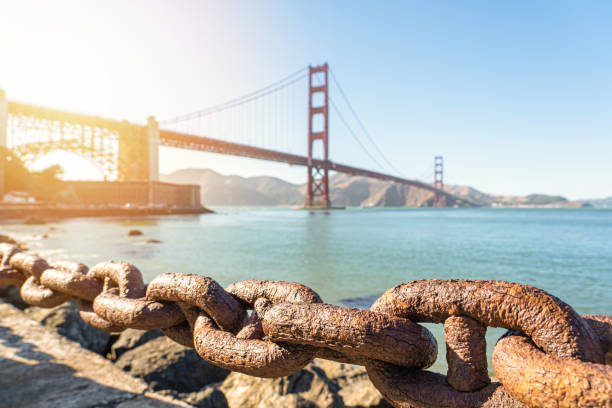 istock Golden Gate Bridge as seen from behind a railing chain at the Presidio. 1180768623