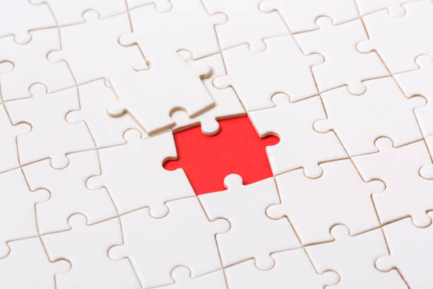 istock Last piece of jigsaw puzzle, red background 1180768721
