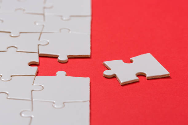 istock Business teamwork concept, Missing puzzle piece on red background. Search for the solution, solve the problem.... 1180768831