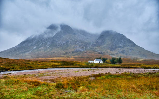 istock Mountain cottage below dramatic wilderness peaks, Glencoe Highlands, Scotland 1180768932