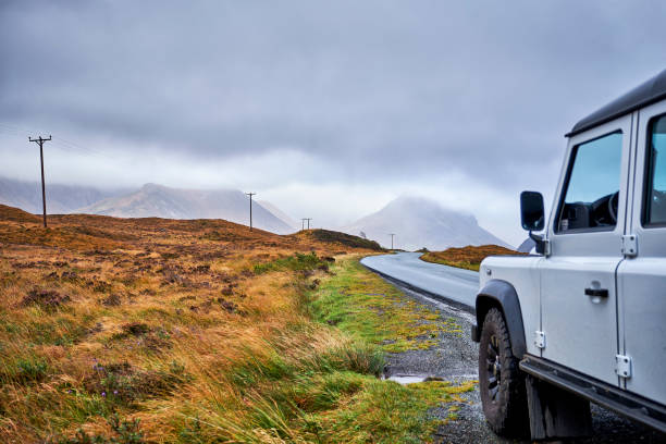 A 4x4 parked along a path during a road trip in Scotland. stock photo