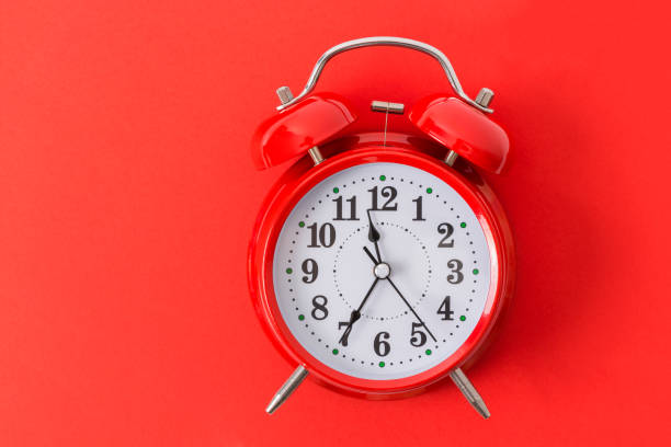 istock Red Alarm Clock On Red Background With Copy space 1180769486