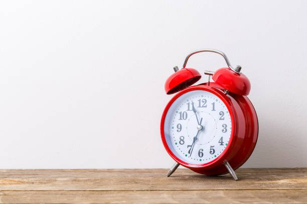istock Old red alarm clock, showing seven o`clock time to wake up 1180770150