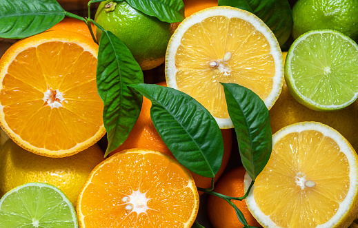 Fruit background. Orange, lemon and lime close-up, macro. Food background. Fresh ripe fruit mix. Fruit pattern and texture.
