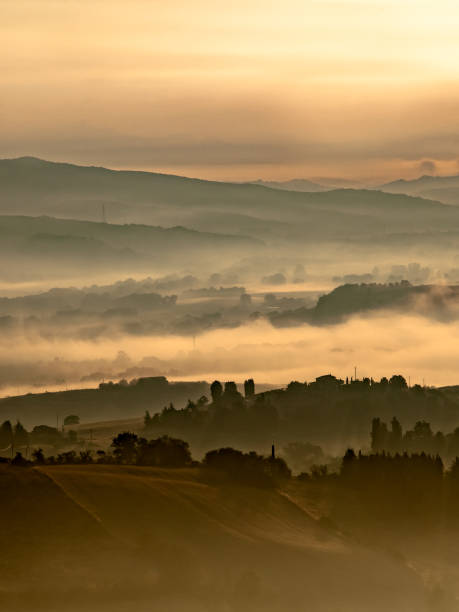 istock Foggy Sunrise over tuscan Hills 1180773223