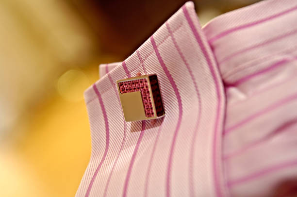 Elegant suit shirt with golden cufflings and low deep of field