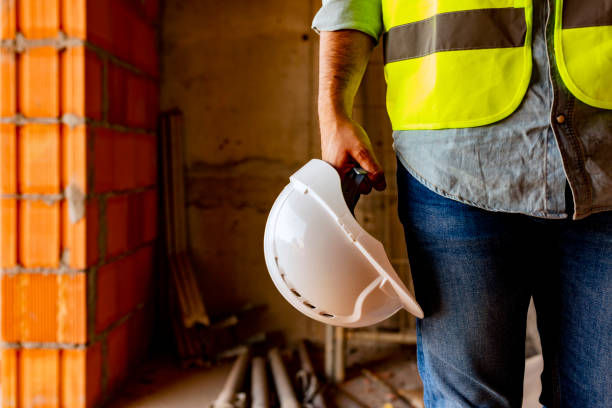 istock Man holding white helmet close up 1180774485