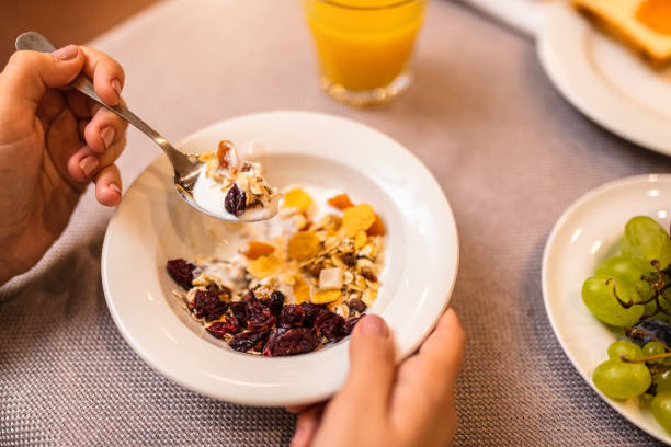 Young woman having muesli for breakfast