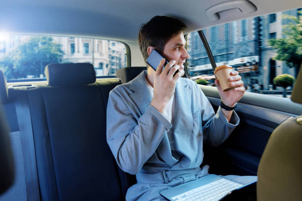 istock Buisnessman talking via smartphone in car 1180774796