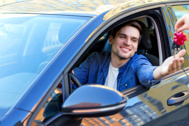 istock Happy buisnessman bought a new car as gift 1180774975