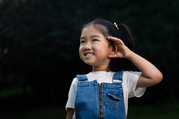 istock Cute Girl Listening 1180774976