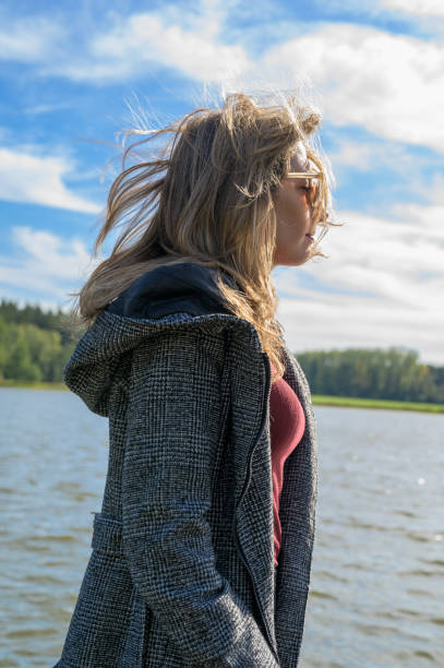 istock A young woman enjoys a nice day in autumn. 1180776058