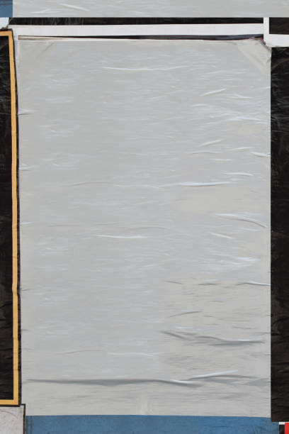 blank crumpled paper poster plastered on dirty wall Blank crumpled paper poster plastered on dirty wall. Background design element with copy space to overlay text and photos. wild posting ad stock pictures, royalty-free photos & images