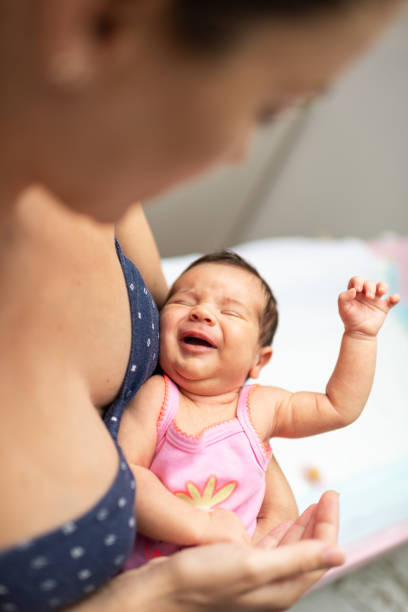 istock Mother comforts newborn baby 1180777744
