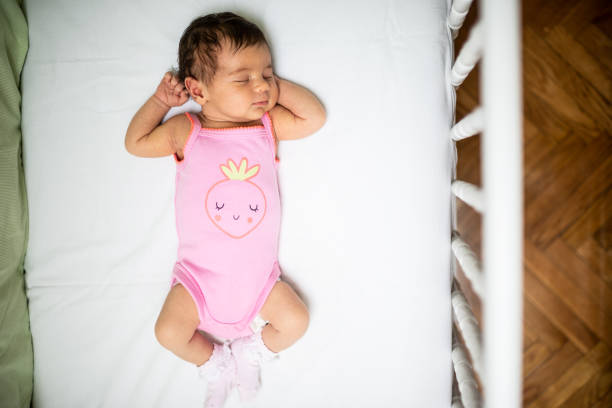 What a wonderful life! Newborn baby girl peacefully sleeping in the crib. High angle view. crib stock pictures, royalty-free photos & images