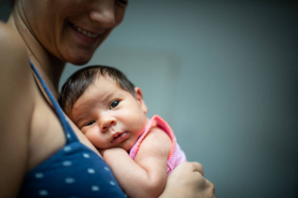 istock Mother holding newborn baby 1180778600