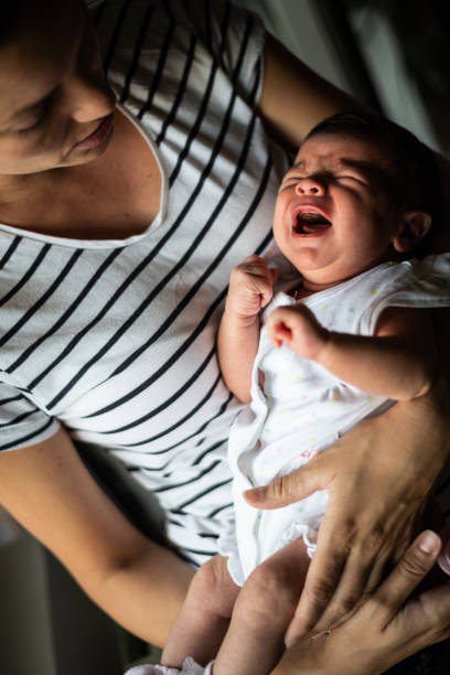 istock Mother comforts newborn baby 1180778702