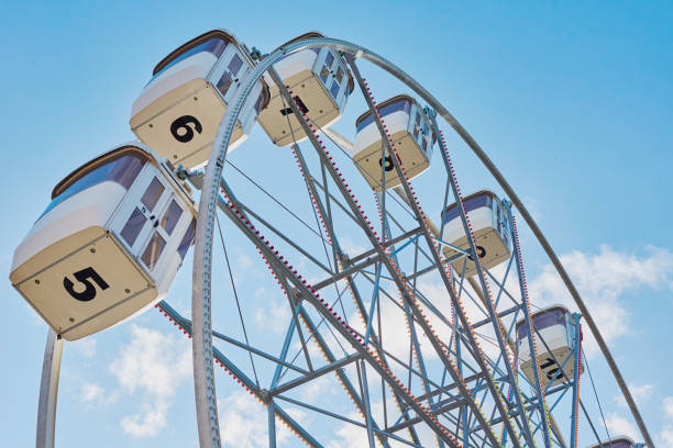 istock Close up ferris wheel against blue cloudy sky 1180779516