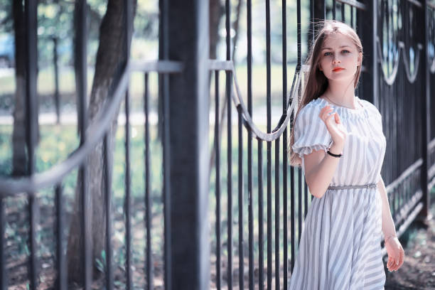 istock A girl in a spring green park 1180779712