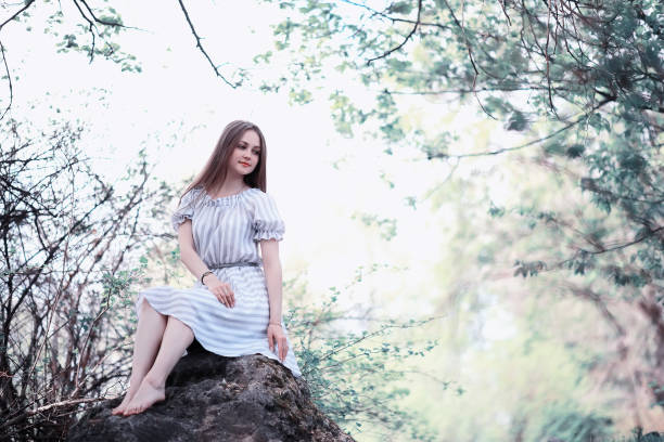 istock A girl in a spring green park 1180779735