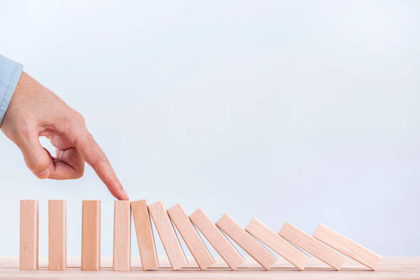 istock Businessman hand stopping the domino effect for management and Solution , concept strategy and successful intervention 1180786710