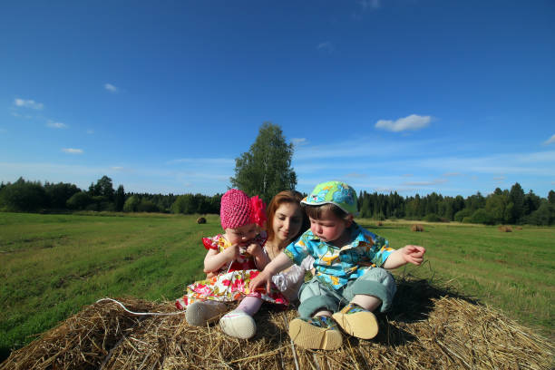 istock mother with twins in field 1180787743