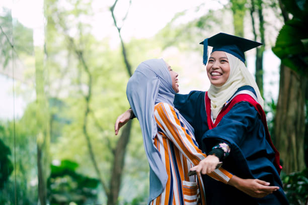 istock Two Young Women Hugging during Graduation Day 1180787897