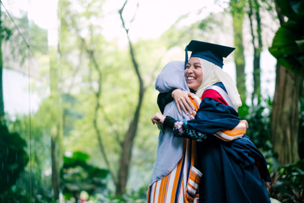 istock Two Young Women Hugging during Graduation Day 1180787912