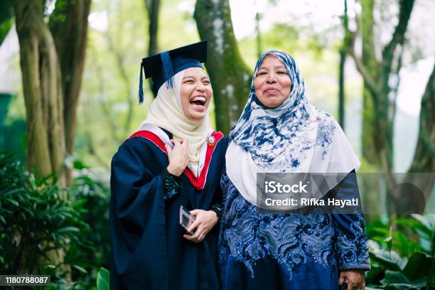 Portrait Of Young Women Celebrating Graduation With Her Mother Stock Photo - Download Image Now