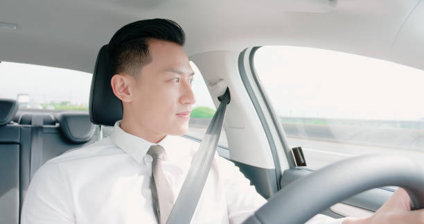 istock business asian man driving car 1180788344