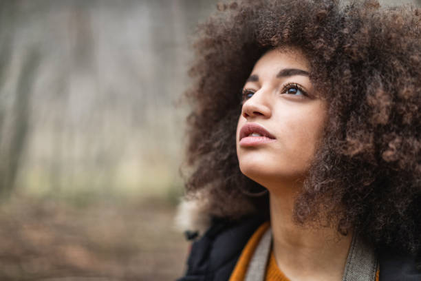 istock Woman in the woods during warm color fall 1180791530