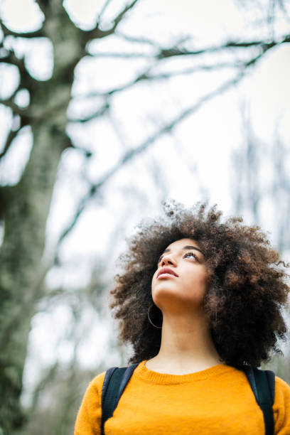 istock Woman in the woods during warm color fall 1180791533