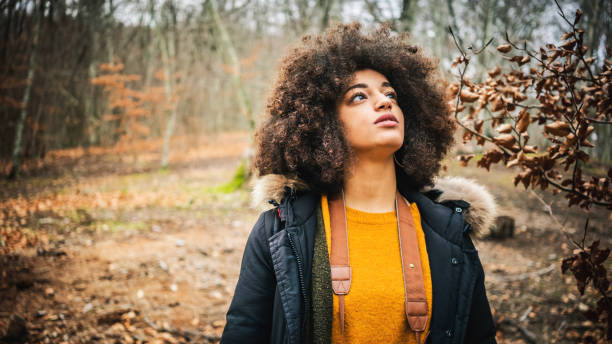 istock Woman in the woods during warm color fall 1180791560