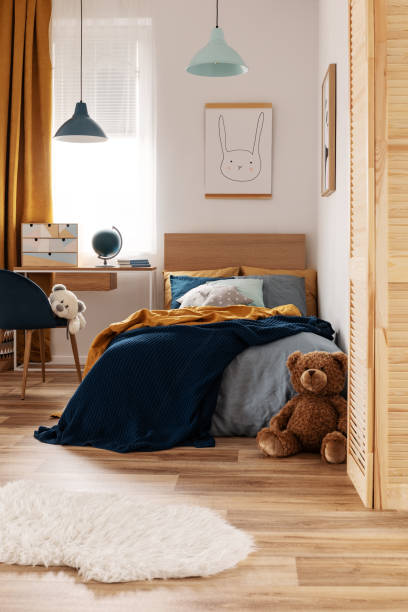 istock Multifunctional bedroom and workspace interior with bed and desk 1180791679