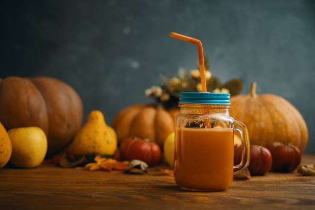 istock Pumpkins juice in bottles with pumpkins. 1180792352