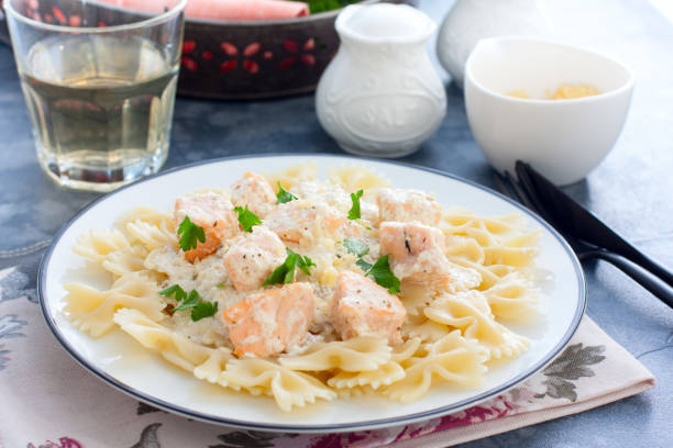istock Farfalle with salmon in a creamy sauce and a white plate, horizontal 1180793811
