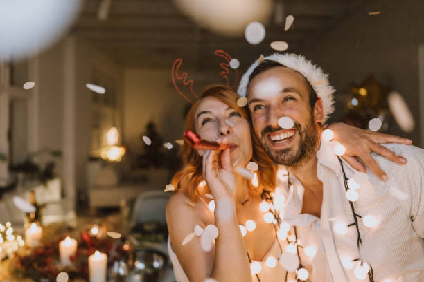 It's Christmas time Photo of young couple on New Year's Eve party social event stock pictures, royalty-free photos & images
