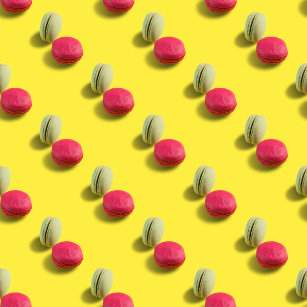 istock seamless pattern of macaroons on a yellow background 1180799725