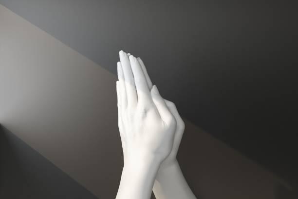 Close-up Buddha hand raised in gesture of Vitarka Mudra isolated on white background. The circle formed by thumb and index finger creates a constant flow of energy information, teaching transmission