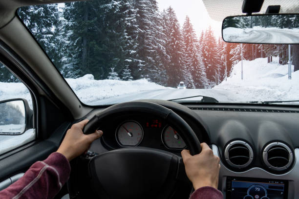 A man drives a car A man drives a car on a winter road car point of view stock pictures, royalty-free photos & images