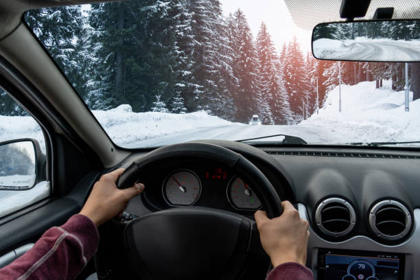 a man drives a car - winter driving imagens e fotografias de stock