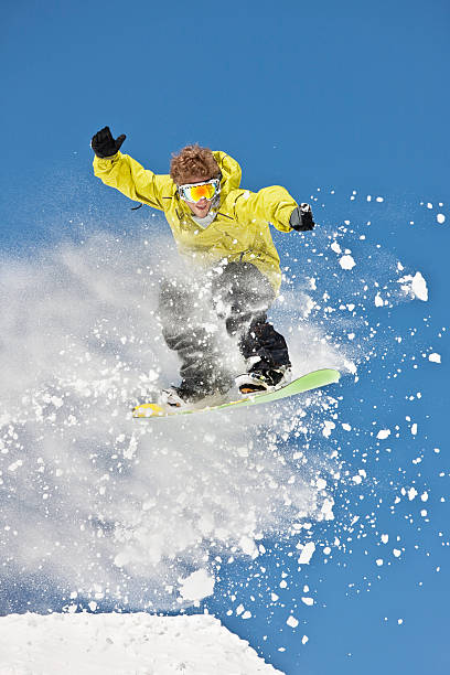 istock Snowboarder Airborne Against Clear Blue Sky 118079998