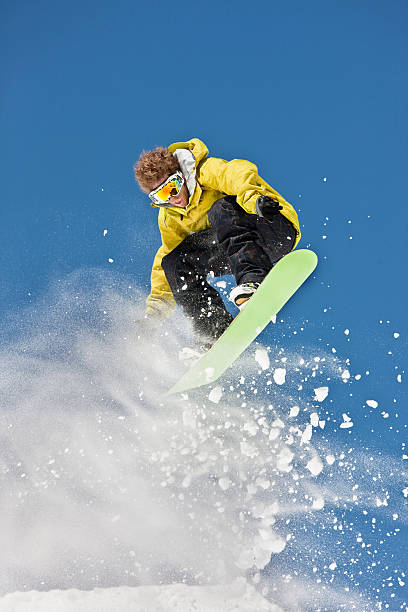 istock Snowboarder Suspended In Air Against Blue Sky 118080006